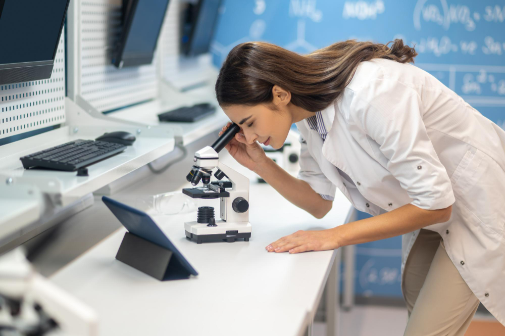 Researcher examining a sample under a microscope